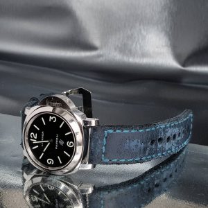 Brutal Blue vintage leather strap by gunny straps with a very distressed surface shown on panerai pam000 wristwatch