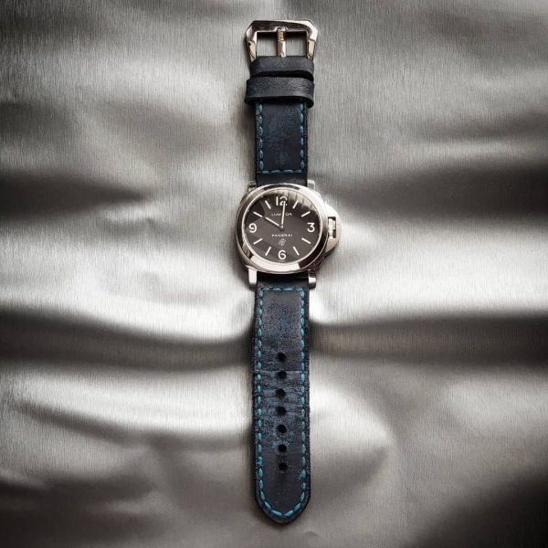 Brutal Blue vintage leather strap by gunny straps with a very distressed surface shown on panerai pam000 wristwatch