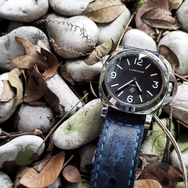 Brutal Blue vintage leather strap by gunny straps with a very distressed surface shown on panerai pam000 wristwatch