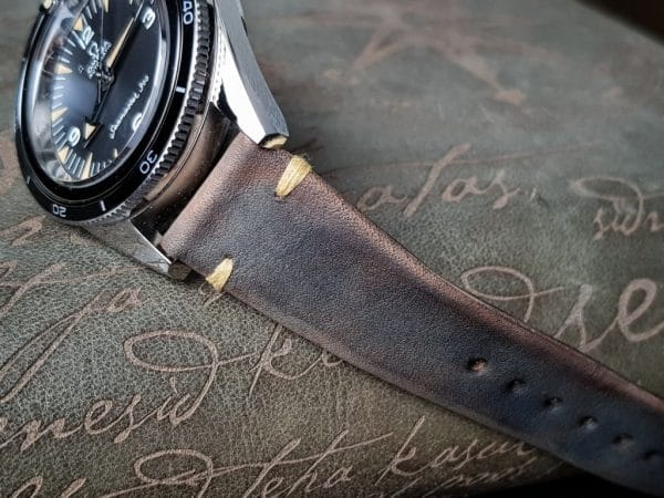 Gurney 1 vintage leather strap by gunny straps with mysterious grey brown color shown on omega seamaster speedmaster wristwatch