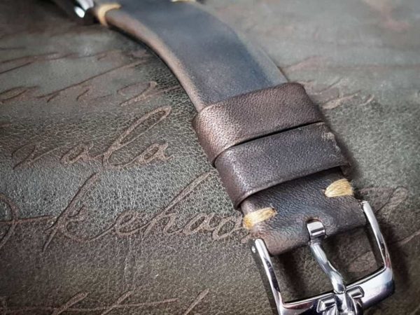 Gurney 1 vintage leather strap by gunny straps with mysterious grey brown color shown on omega seamaster speedmaster wristwatch