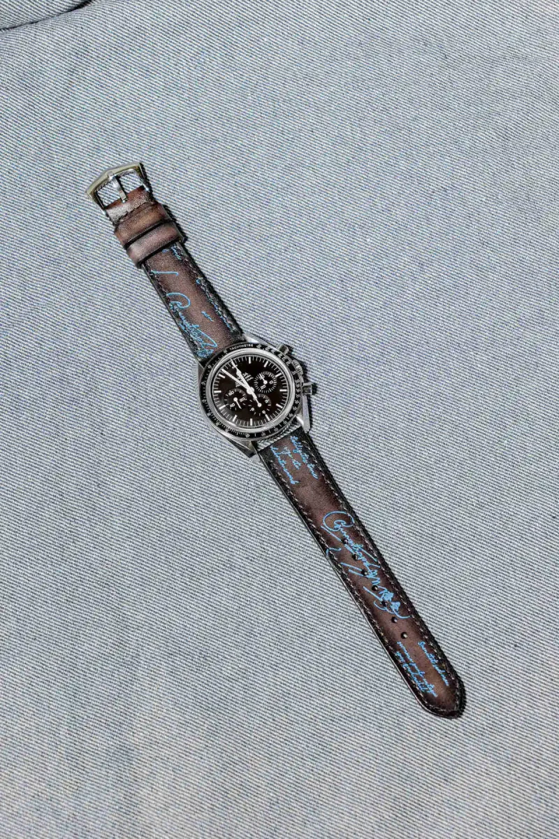 Black Patina with Blue Scritto Strap on Omega Speedmaster by Gunny Straps