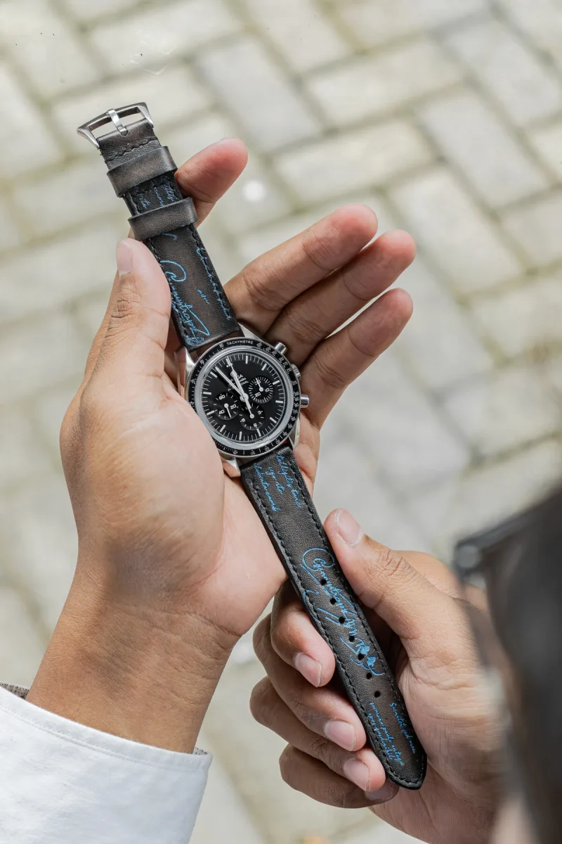 Black Patina with Blue Scritto Strap on Omega Speedmaster by Gunny Straps